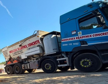 Volumetric concrete mixer supplying fresh concrete on site